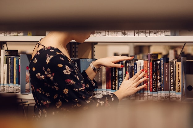 girl searching in library education books